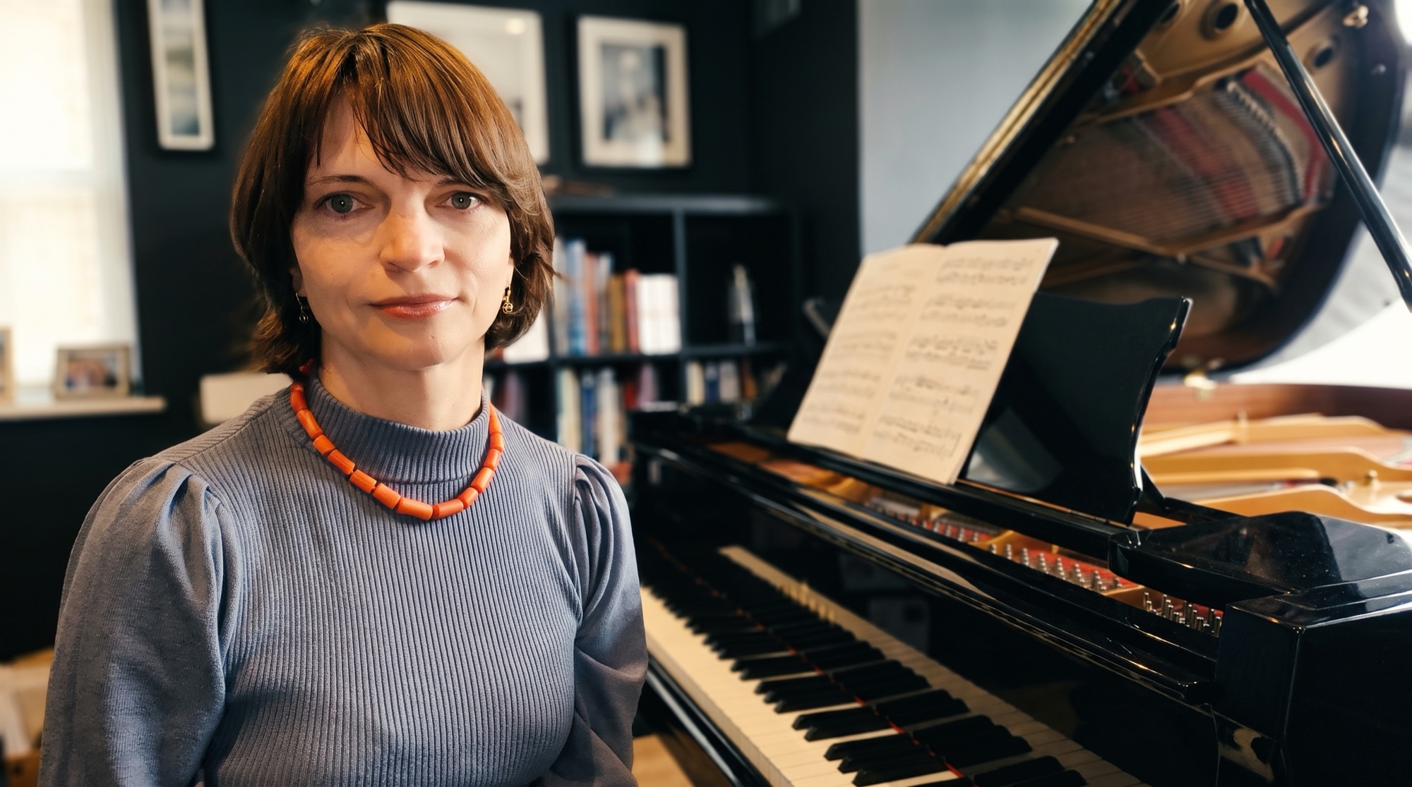 Tetyana Vlasyuk beside the grand piano in her Dublin studio